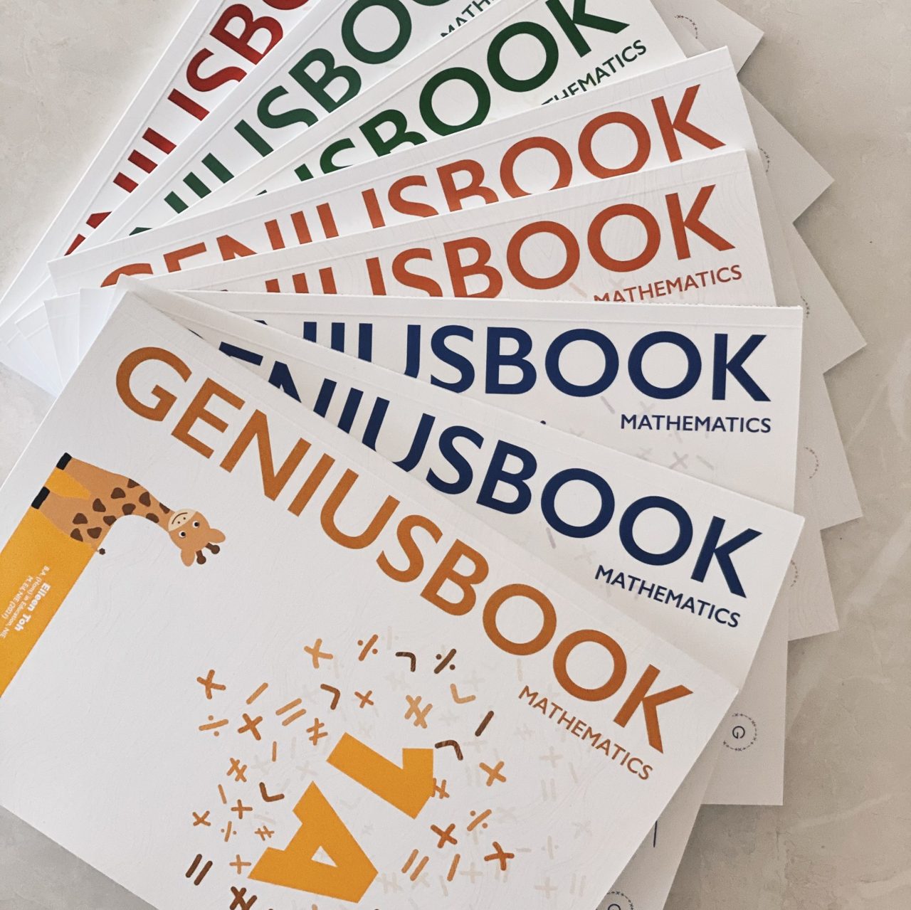 Genius Plus Academy's in-house textbooks and workbooks