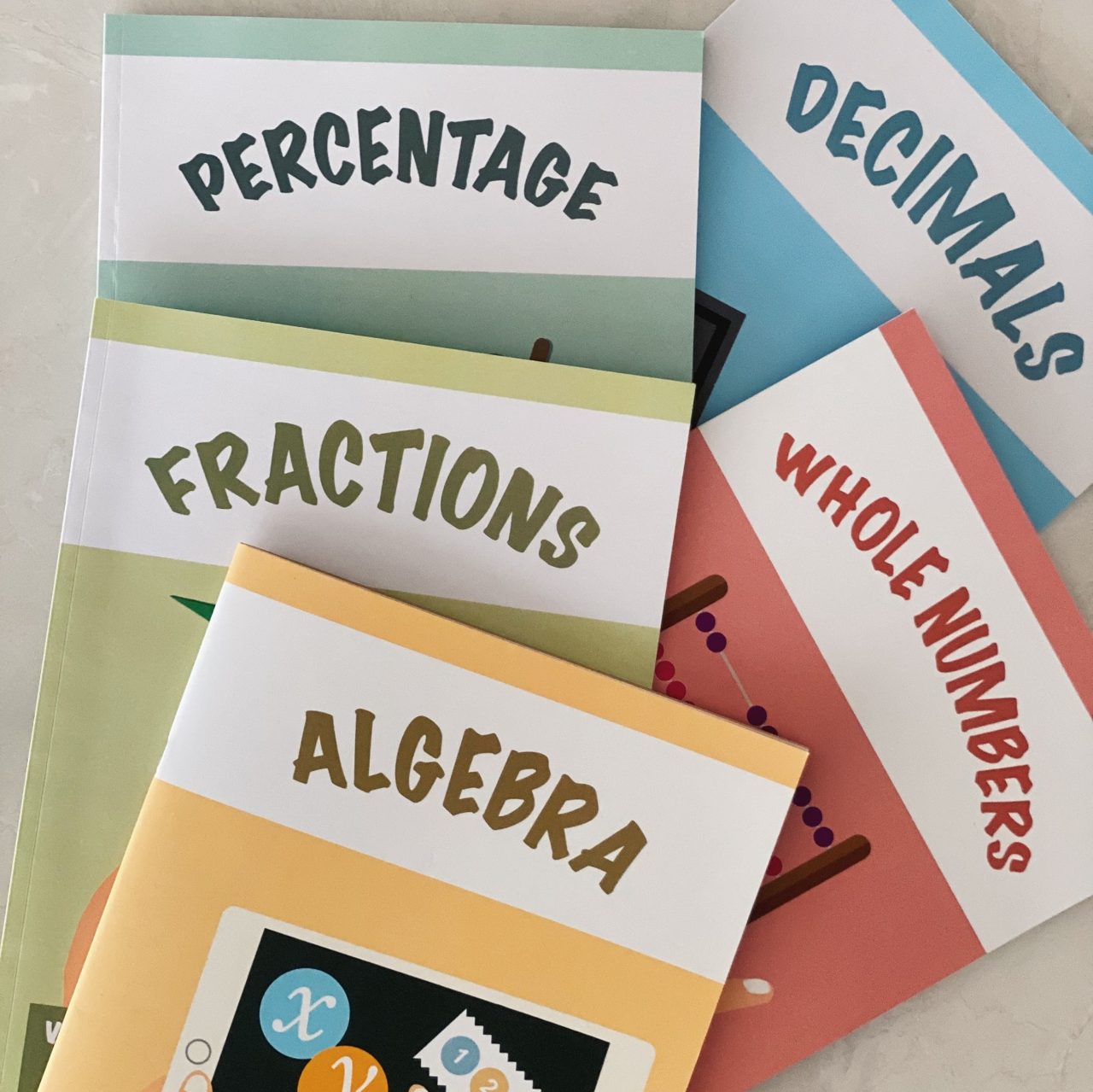 Genius Plus Academy's in-house math workbooks that every tutor teaches from